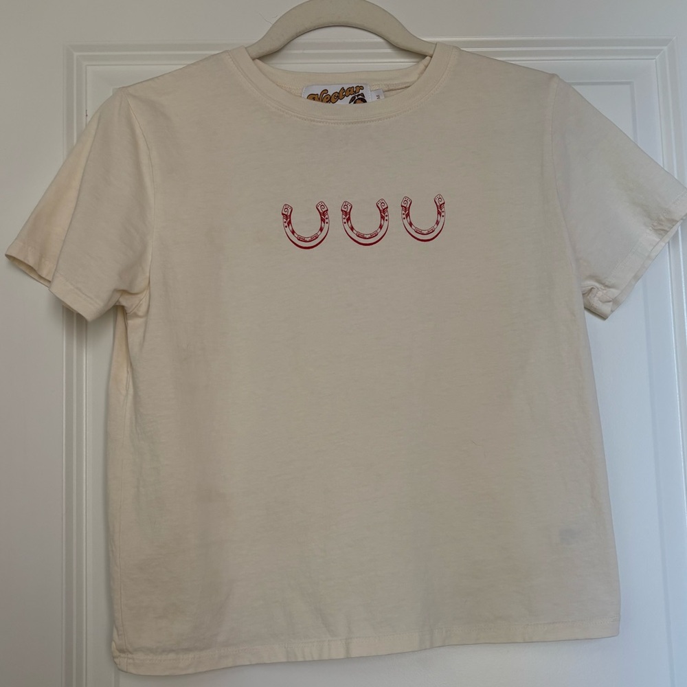 Stylish Cream Tee with Red Horseshoe Accents
